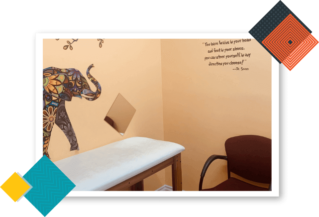 California Kids Pediatrics Clinic Care Unit with an elephant painting on the wall, pediatric examination table, and maroon-colored chair.