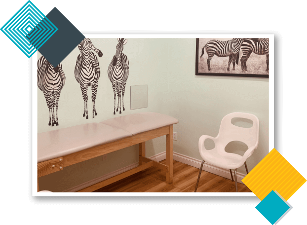 California Kids Pediatrics Clinic Care Unit with zebra painting on the wall, pediatric examination table, and a white chair. 