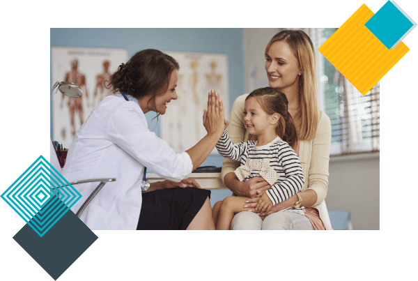 A pediatrician gives a high five to toddler cradled by her mother during her well child visit appointment. 